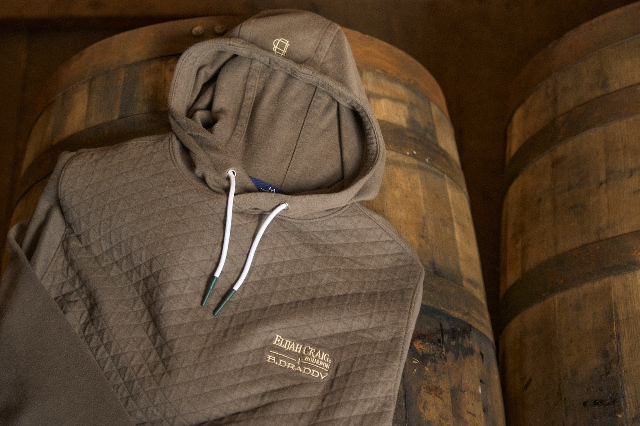 Elijah Craig × B.Draddy quilted hoodie on bourbon barrels